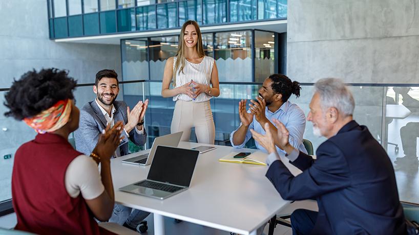 Modern female manager is working on improvement of business results while spending time in company hallway with her colleagues.