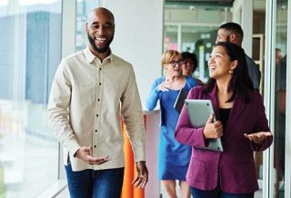 group of people walking and talking in a corridor