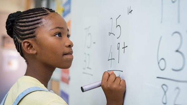 Girl solving mathematical addition